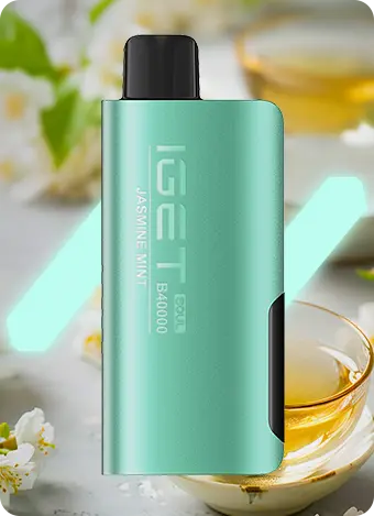 Green vape device with black accents on a blurred background of tea and flowers